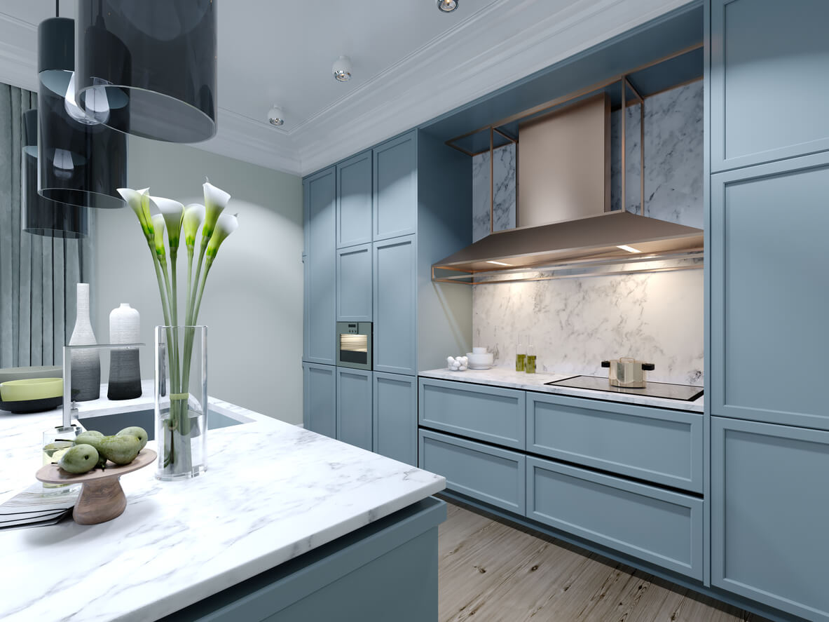 Modern trendy kitchen with light blue faded coral color furniture.